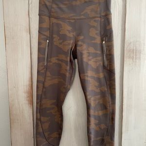 Athleta yoga pants. Size Medium. Gray gold camo with zip pockets on the sides.